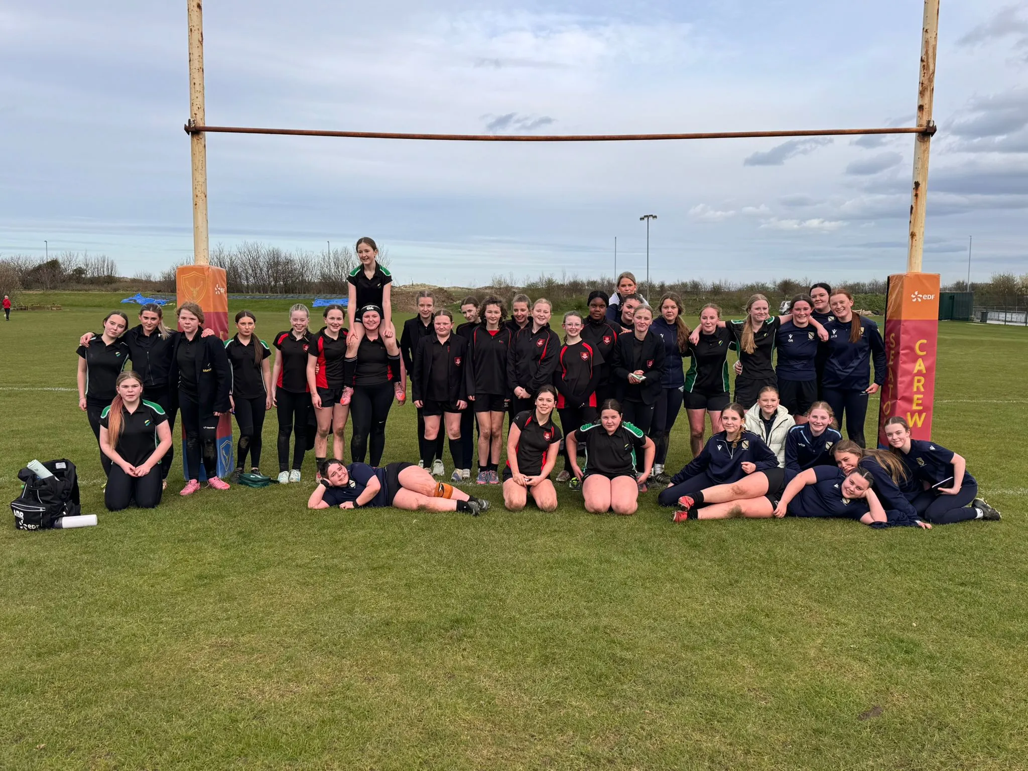 A group of young rugby players together on the pitch